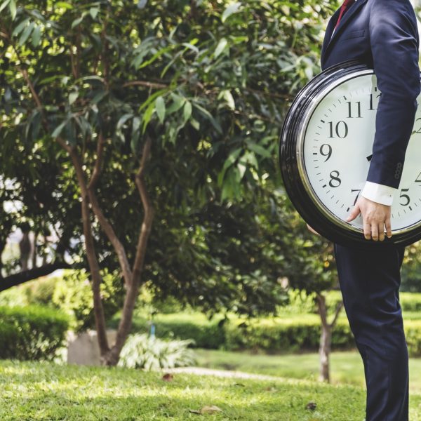 man holding a clock